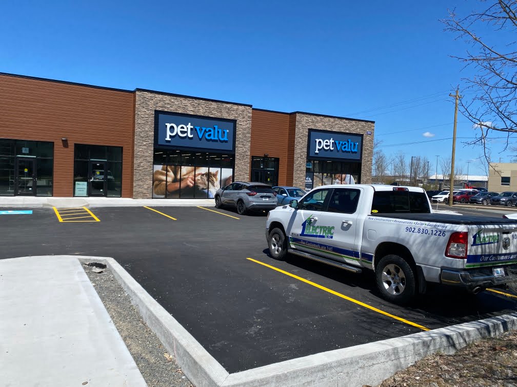 Residential electrician Nova Scotia truck parked outside a new Pet Valu location under sunny skies.