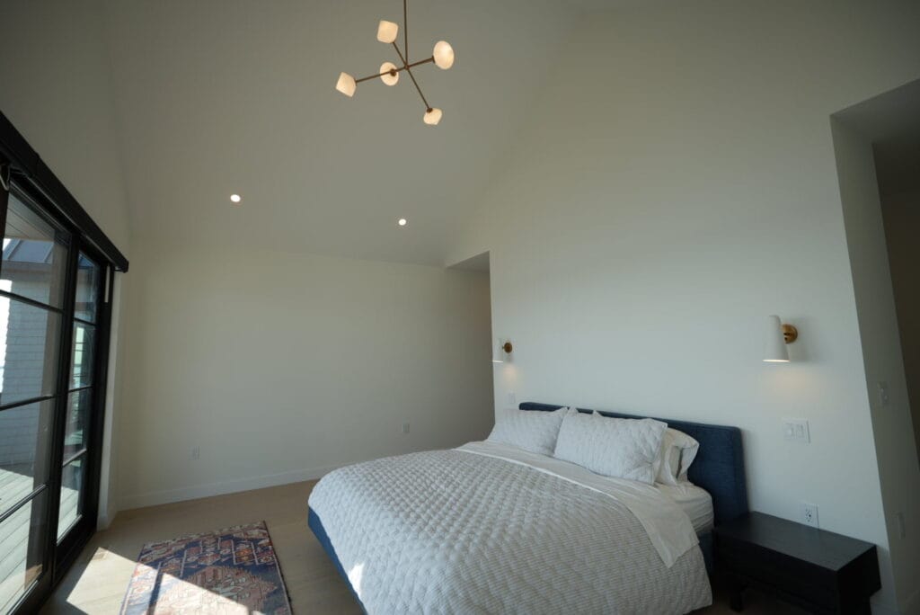 Modern bedroom with recessed lighting and sconces installed by a top-rated Halifax electrician