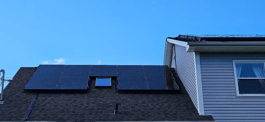 Rooftop view of a residential solar panel system designed for Solar Panel Installation Halifax, with panels installed around a skylight.